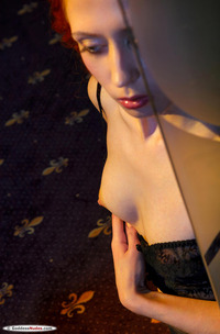 Madelen Teases With Shaven Curves And Fishnet Pantyhose In A Tempting Indoor Striptease