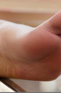 Spice Spreading Legs Teasing With Thongs While Barefoot On Couch Indoors