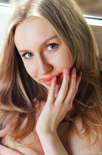 Lia Pink Kneels To Offer An Enticing Rear View Of Her Voluptuous Booty