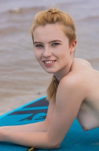 Erika Fox Lounging On Paddle Board Relaxing With Breasts For Beach Pleasure