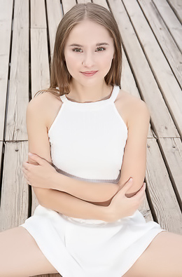 Sasha Quinn Smiling Playfully As Her Short Skirt Flips Up To Reveal She’s Not Wearing Panties