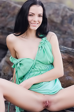 Chick undresses on beach.