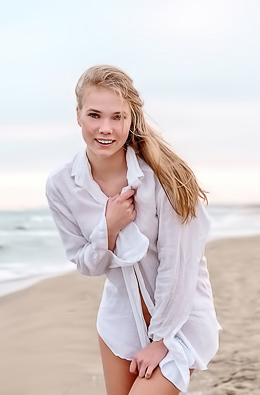 Luise Vivacious Blue-eyed Babe Stretches Out In The Warm Sand